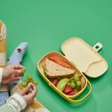 Żółte pudełko IKEA KAPTENSFISK otwarte z posiłkiem — inne zdjęcie aranżacyjne.